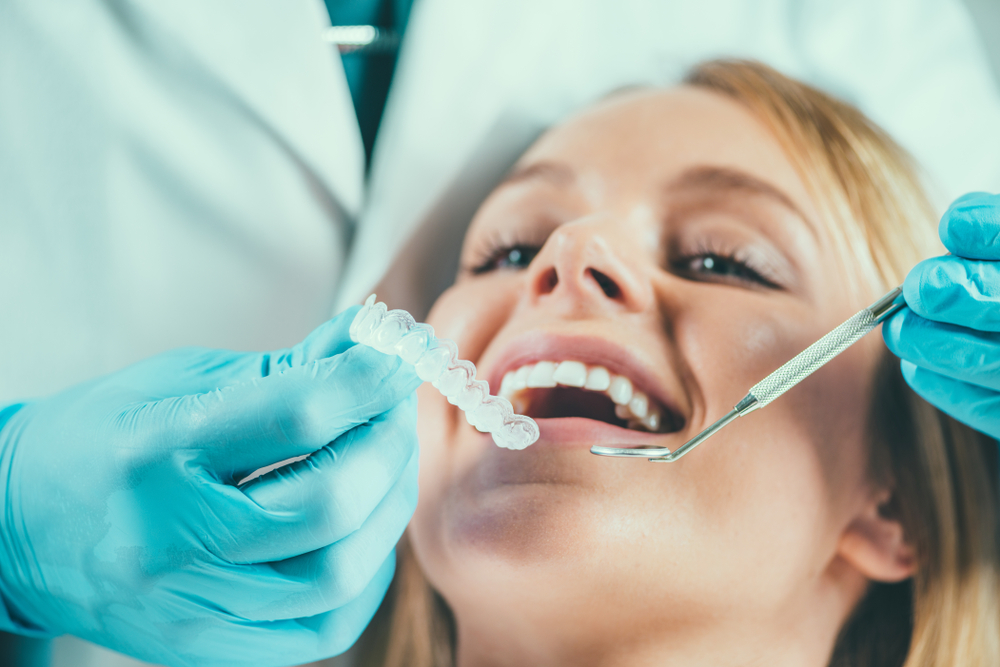 a woman getting her teeth professionally whitened at the dentist